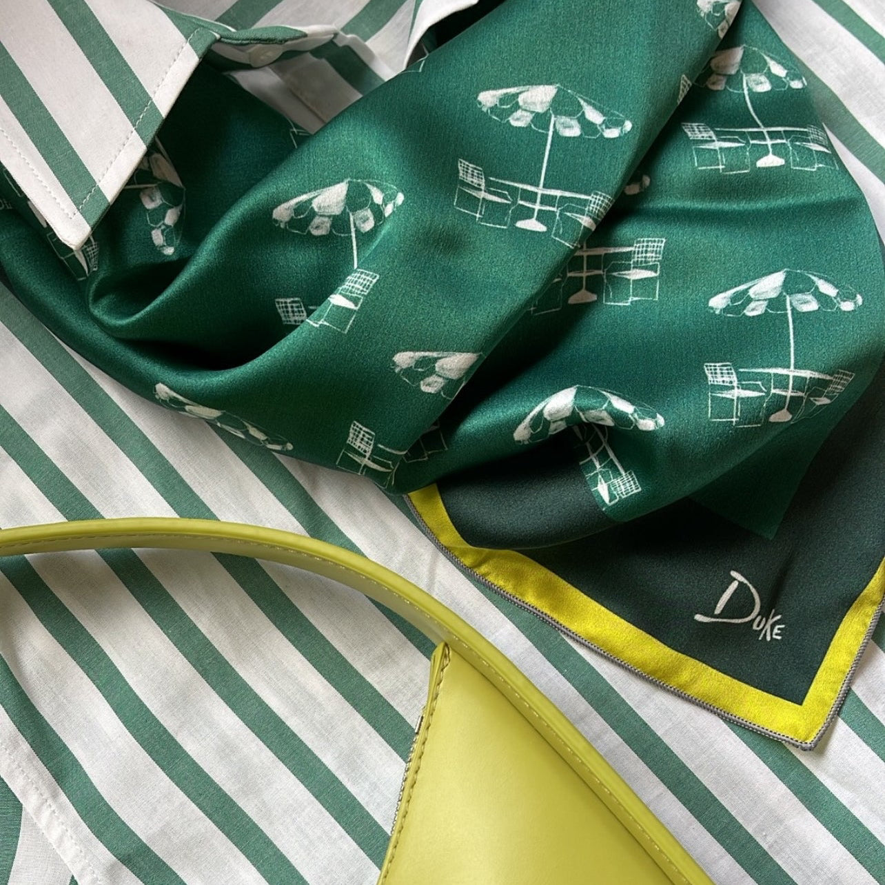 Golf fashion accessory featuring a silk green scarf inspired by the umbrellas at the most famous golf tournament hosted in Augusta, Georgia.