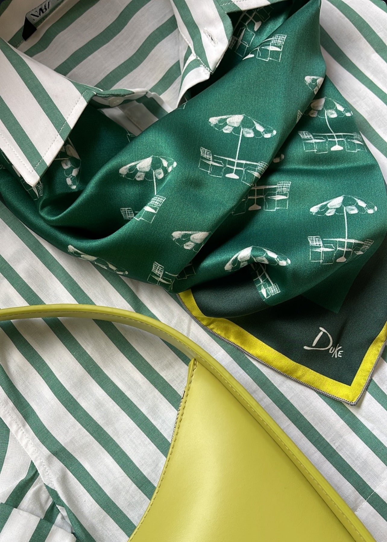 Golf fashion accessory featuring a silk green scarf inspired by the umbrellas at the most famous golf tournament hosted in Augusta, Georgia. 