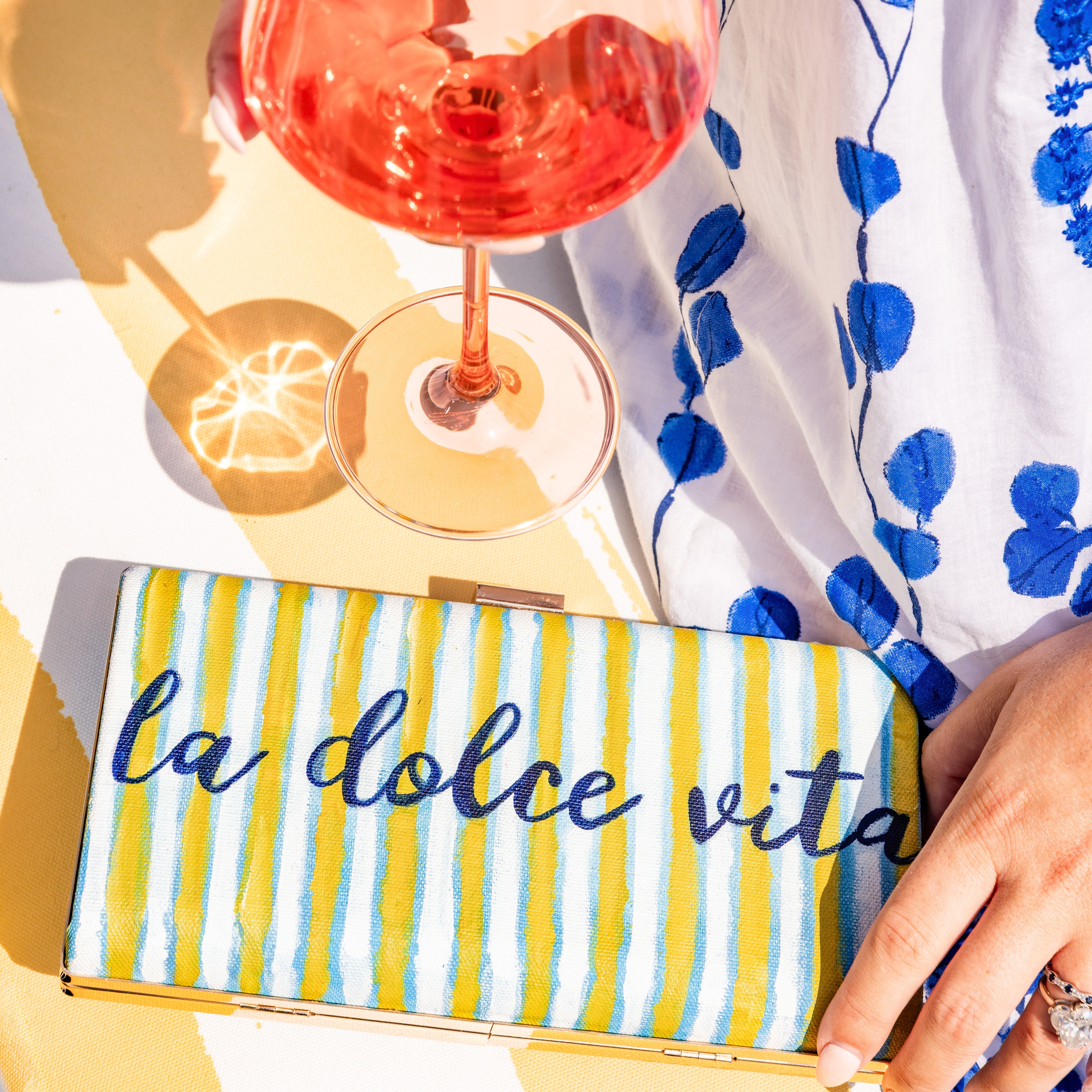 Hand painted clutch by artist Laura Duke inspired by Amalfi Coast Lifestyle. 
